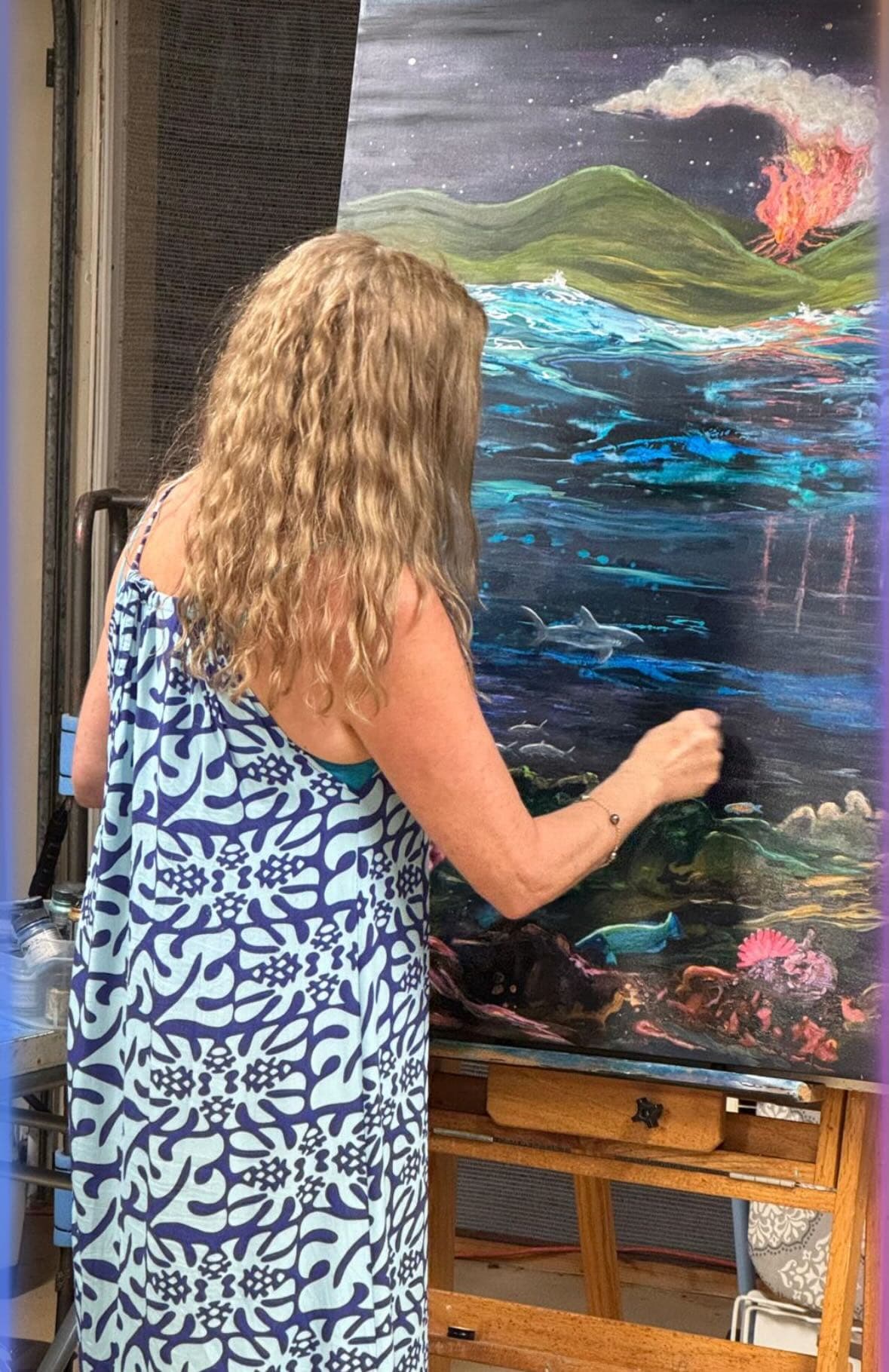 Deona painting at her easel