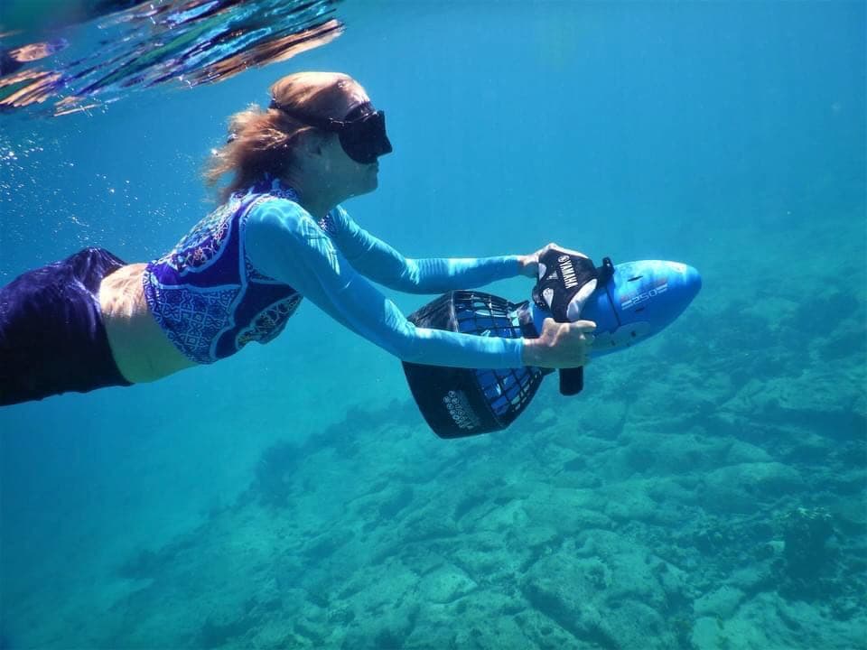 Deona exploring underwater with a sea scooter